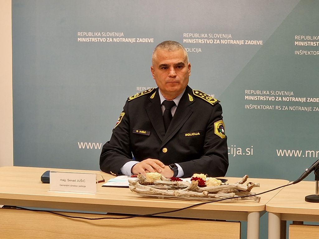 Generalni drektor policije mag. Senad Jušić sedi za mizo, med izjavo na novinarski konferenci