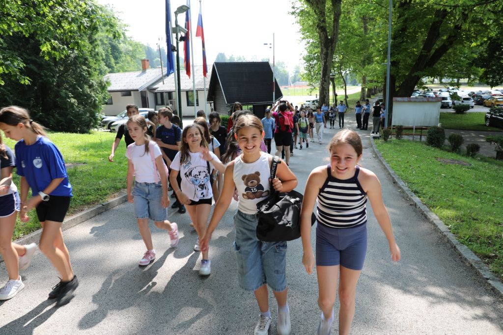 "Četa" nasmejanih otrok se vije po klancu navzgor do Policijske akademije.