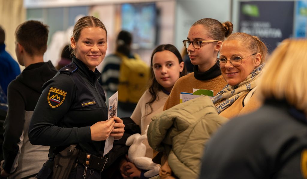 A young police student talking to visitors