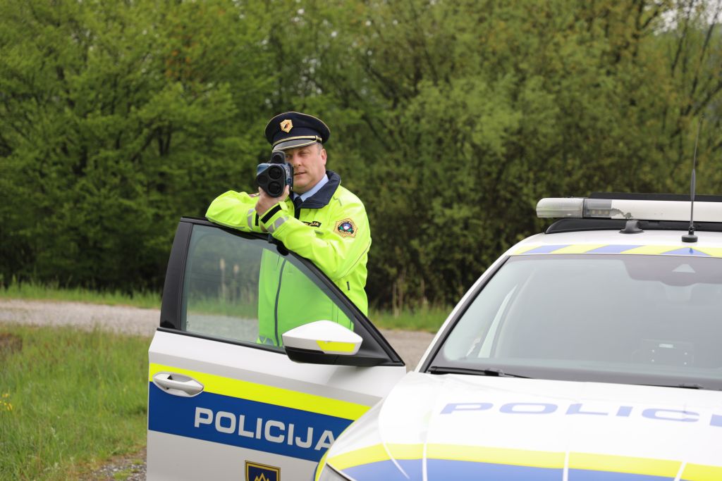 A traffic police officer is measuring speed