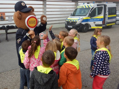 Police officer Leon, the bear, with a group of children