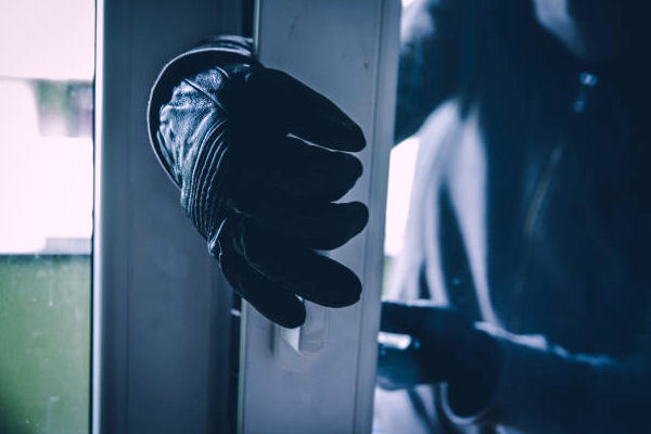 picture of a burglar's hand, breaking into