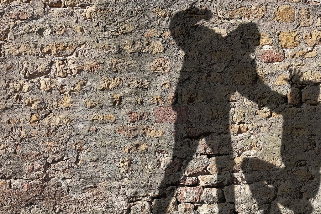 picture of a person's shadow threatening another person